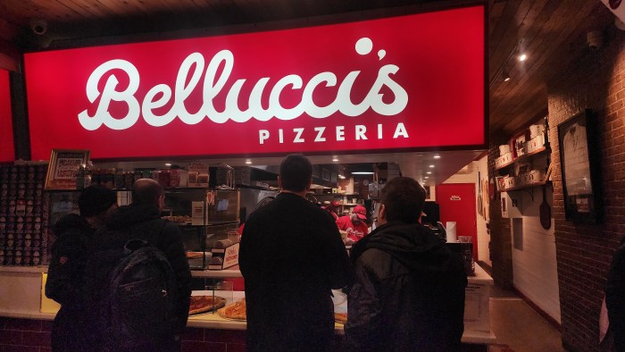 Participants sample pizza at Andrew Bellucci's Pizzeria on 30th Avenue. Photo: Shane O'Brien