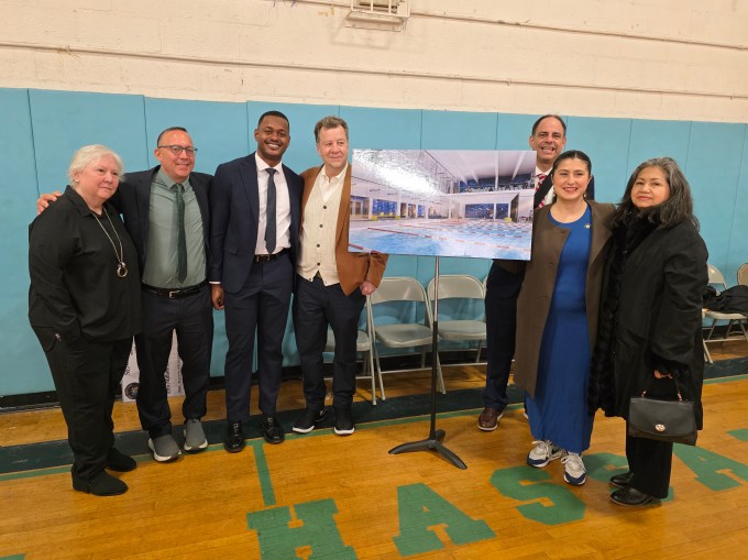 Ramos, Constantinides and VBGCQ board members pose with renderings for the organization's new swimming pool. Photo: Shane O'Brien